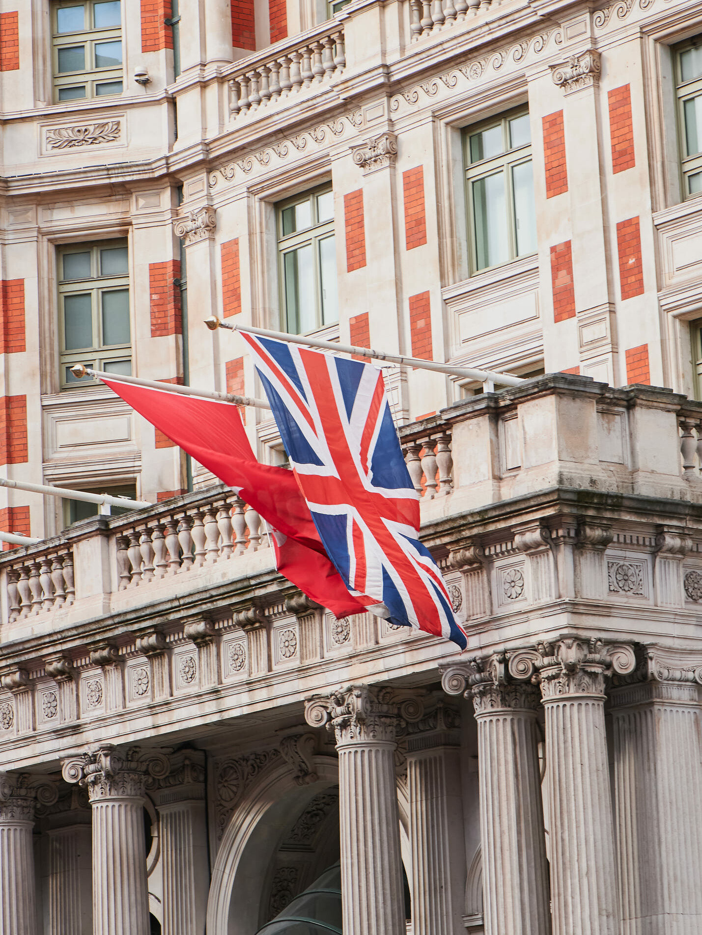 Edwardian red brick and stone façade with a Union Jack flag in London