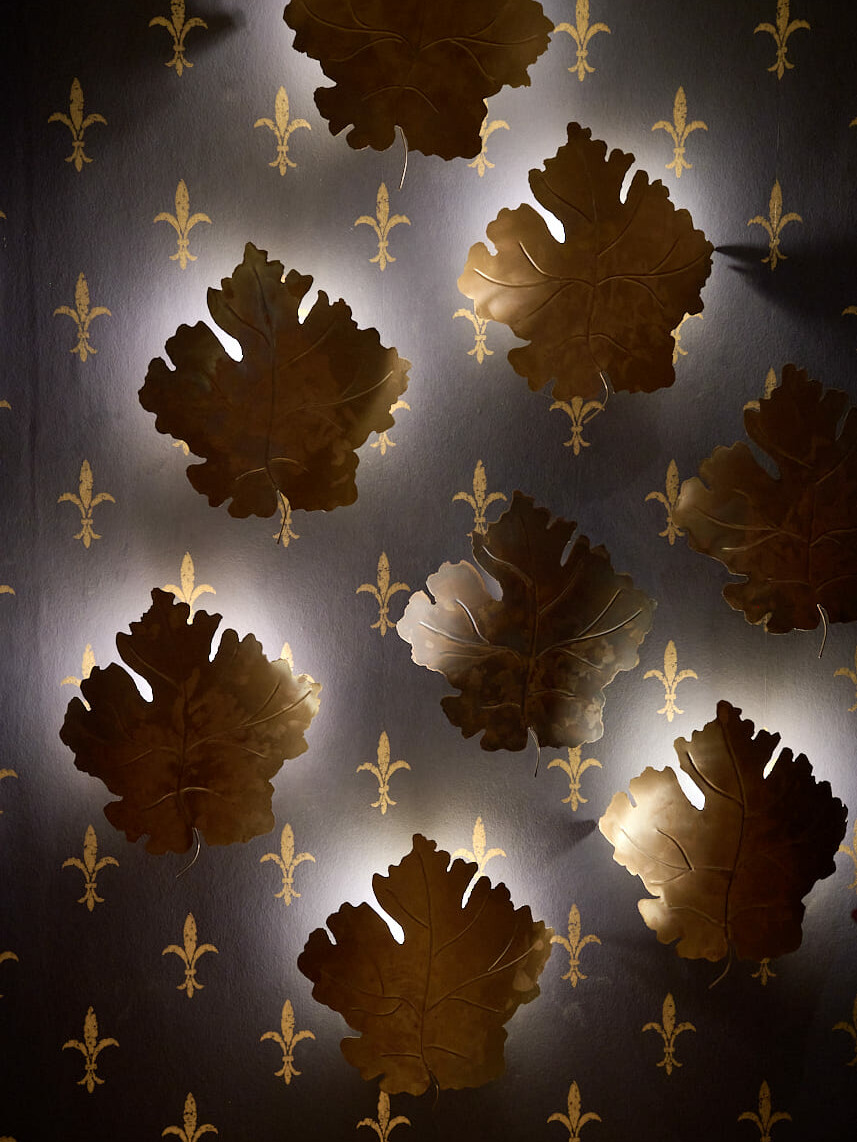 Brass vine leaf wall lights on Florentine lily wallpaper at Cantinetta Antinori London